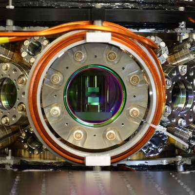A metal piece of equipment with a round open chamber in the center.
