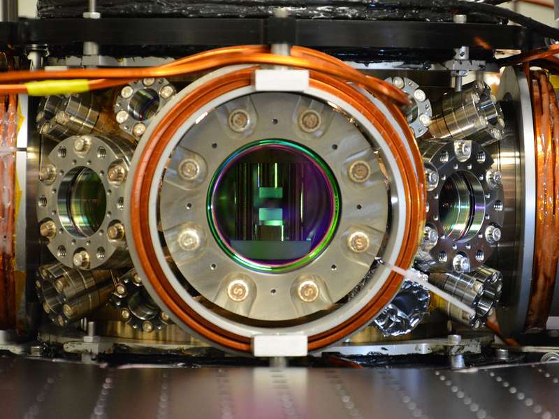 A metal piece of equipment with a round open chamber in the center.