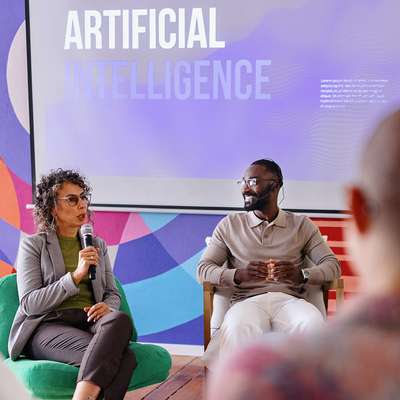 Group of people attending an AI panel discussion.