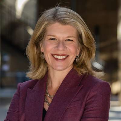 Nora Freeman Engstrom smiling and posing for a profile photo outdoors on the Stanford campus.