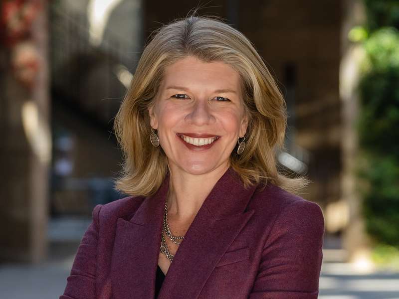 Nora Freeman Engstrom smiling and posing for a profile photo outdoors on the Stanford campus.