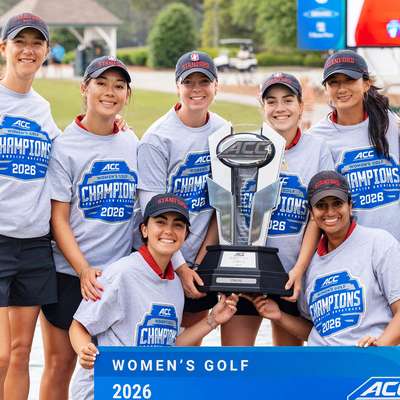 Stanford women's golf team celebrates their 2026 ACC championship victory while holding a large trophy.