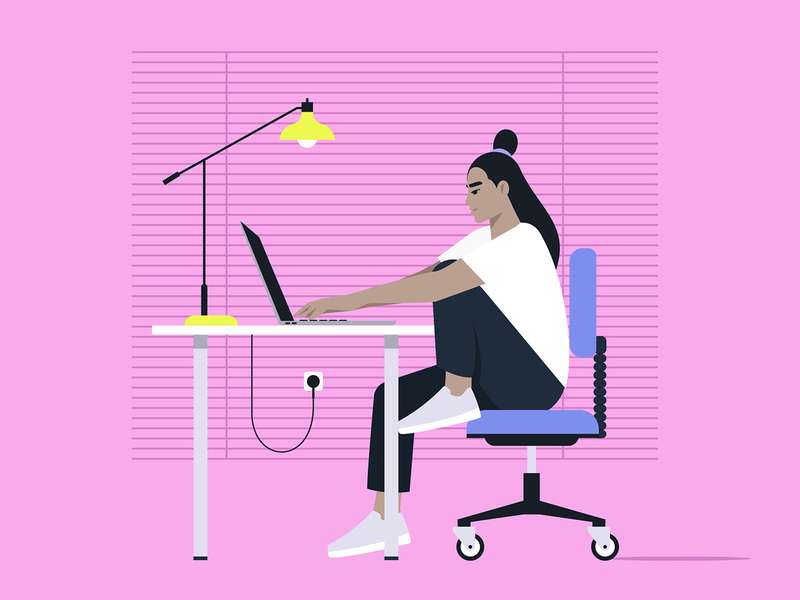 A woman works at a desk on a laptop, sitting in a chair, with a bright lamp and pink background.