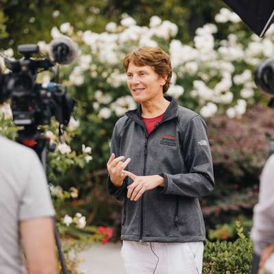 Faculty member in Stanford jacket speaking about her work