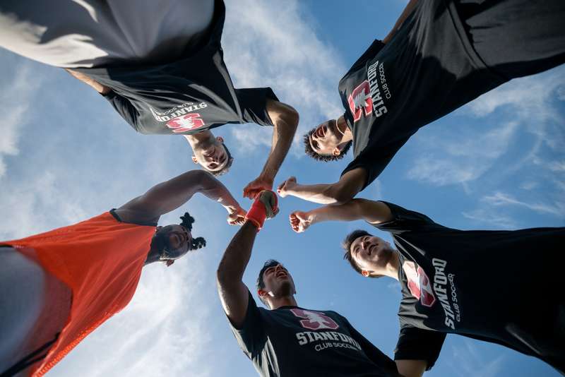 Stanford Club soccer group fist bump