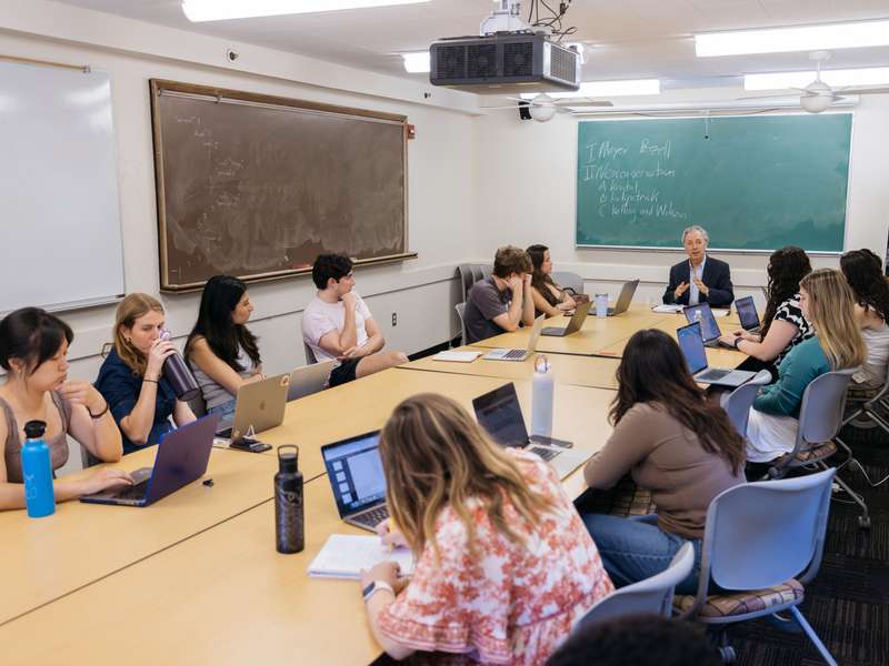 Students sit around a large table in a seminar course as part of a Stanford Civics Initiative course