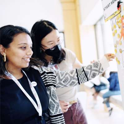 Students at the whiteboard, at Stanford's AI Tinkery space