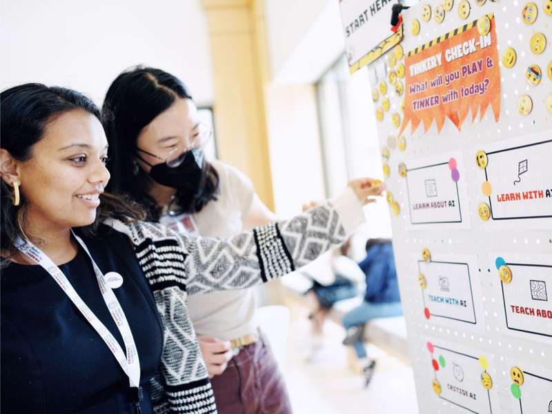 Students at the whiteboard, at Stanford's AI Tinkery space