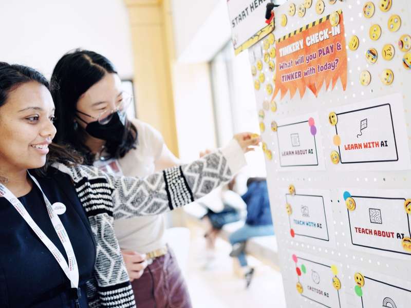 Students at the whiteboard, at Stanford's AI Tinkery space