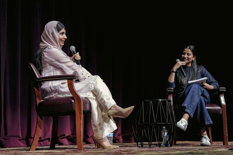 Women having conversation on stage