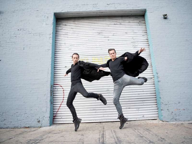 Jason Oremus McLeish jumping with his creative partner in the dance duo Hammerstep
