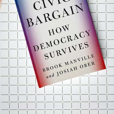 The cover of "The Civic Bargain: How Democracy Survives" by Brook Manville and Josiah Ober, laid flat on a grid-patterned surface.