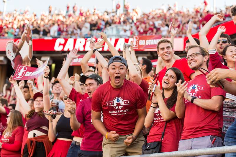 Stanford students cheering at a Cardinal football game.