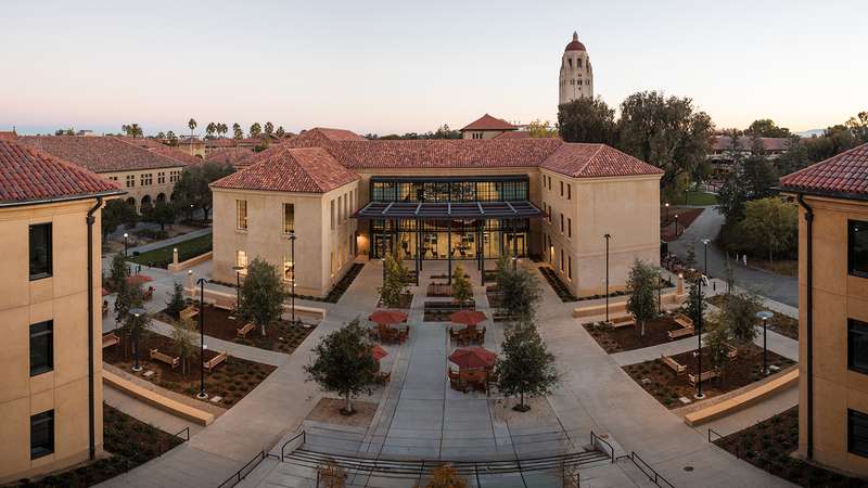 An aerial panoramic view of the Graduate School of Education's Angela Nomellini and Ken Olivier (ANKO) Building in softly fading light.
