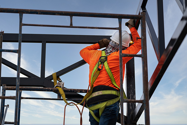 A welder works on a roof.