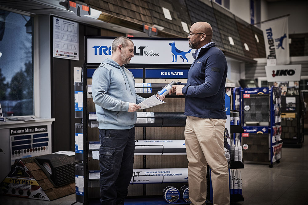 QXO employee and customer discussing TRI-BUILT