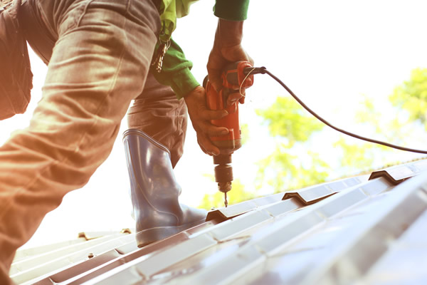 Seasonal employee installs a metal roof