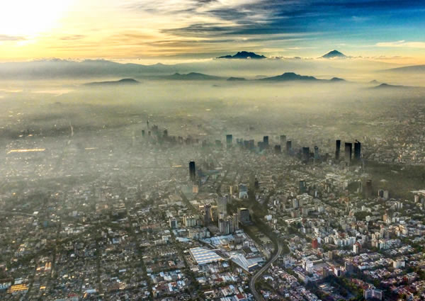 A bird's eye view of a cityscape blanketed in smog