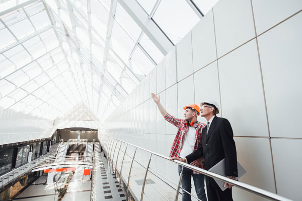 Roofer and client looking at a completed glass dome