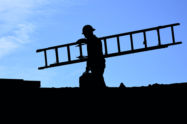 Contractor with ladder crossing a roof