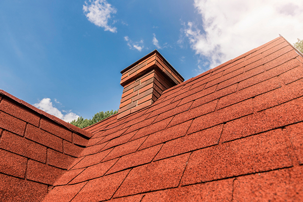 Roof with new colorful shingles on a sunny day