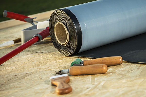 EPDM rool on a roof with tools