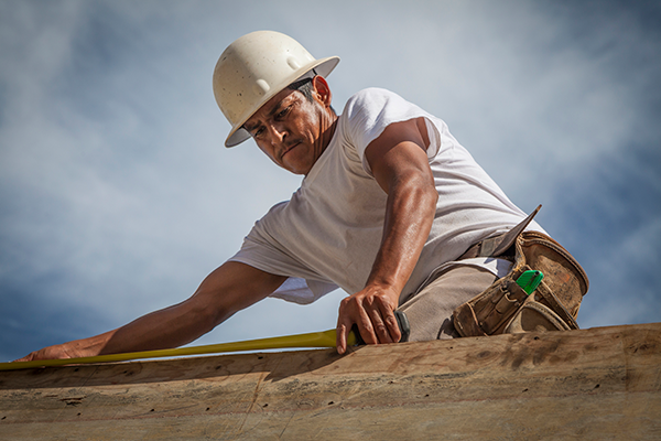 Hispanic roofer on the roof
