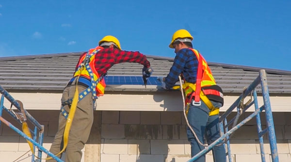 Contractors install a residential roof.