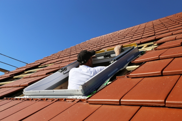 A contractor installs a skylight.