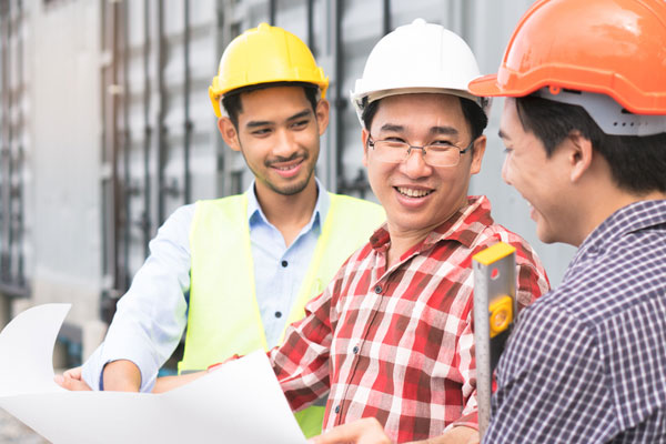A trio of contractors discussing EPDM roofing