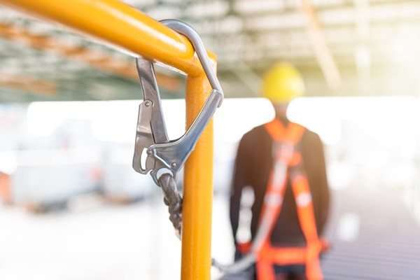 Contractor wearing a fall prevention harness
