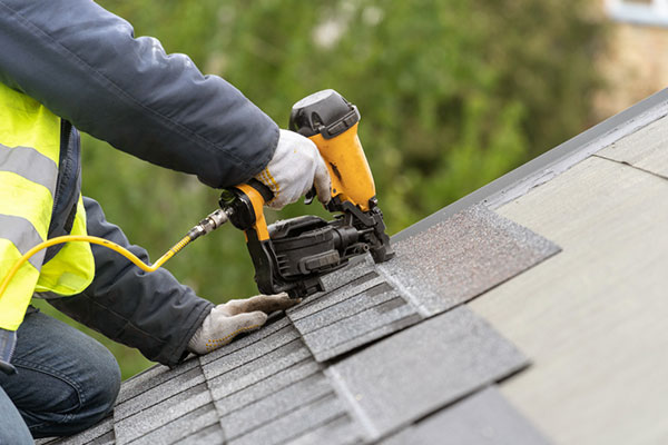 A homeowner installing shingles.