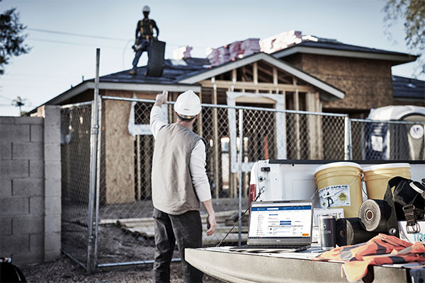 contractor directing roofer on the roof