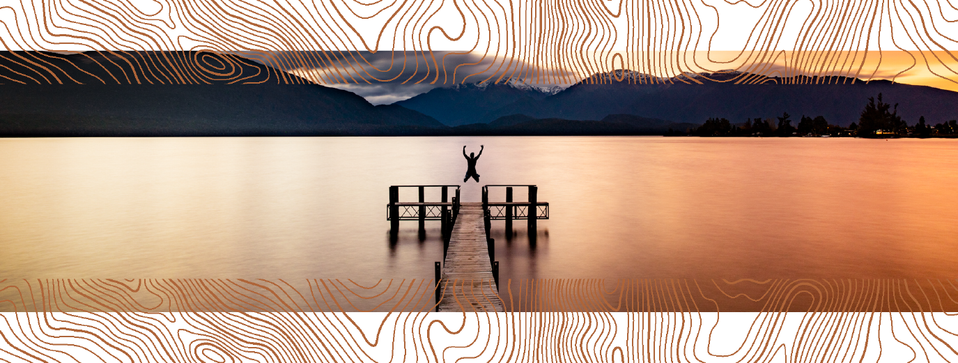 person jumping into a lake in an international location