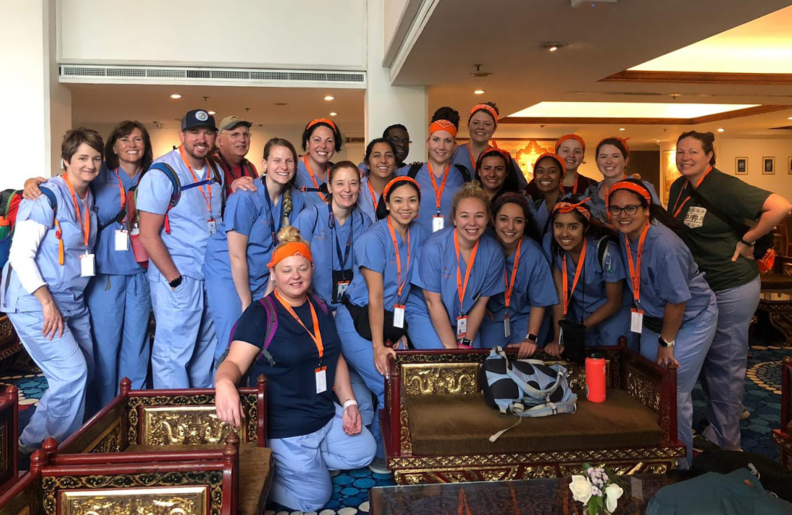 Group of healthcare workers in scrubs pose for photo
