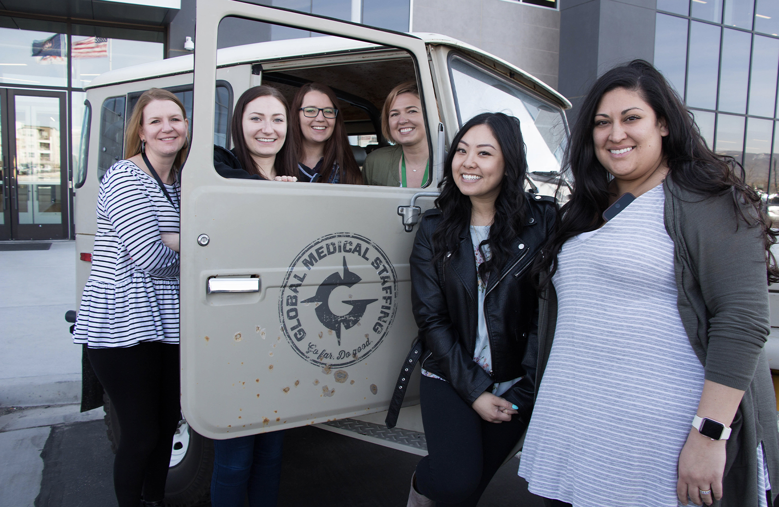 Employees in front of a GMS car