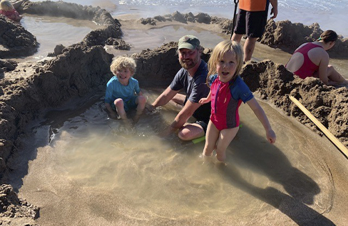 Dr. Parrish's husband and daughters on NZ beach