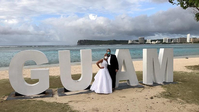 Drs Paul and Holly Llobet on beach in Guam