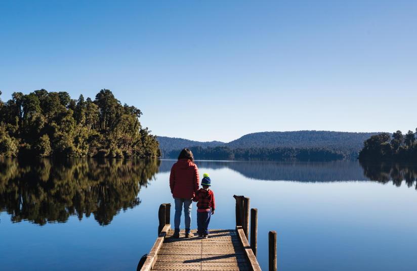 picture of parent and child looking at view from a pier in NZ