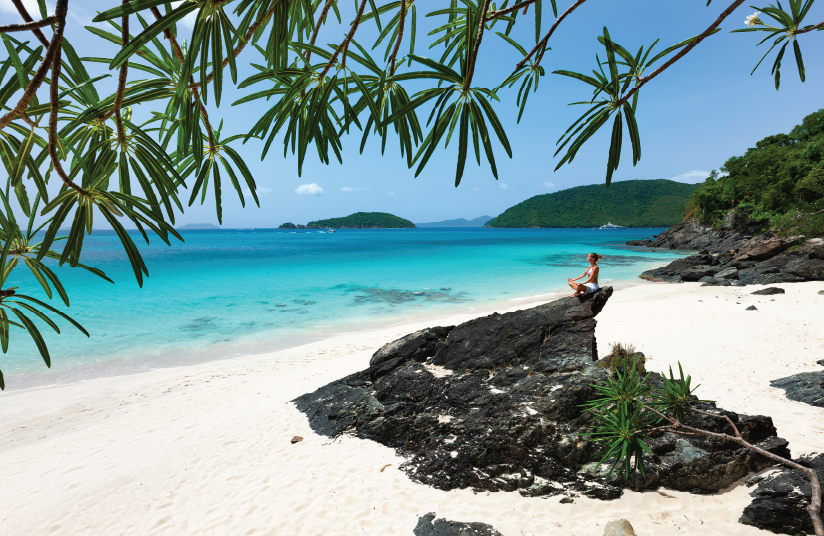 Picture of a doctor sitting on a beach in the Caribbean