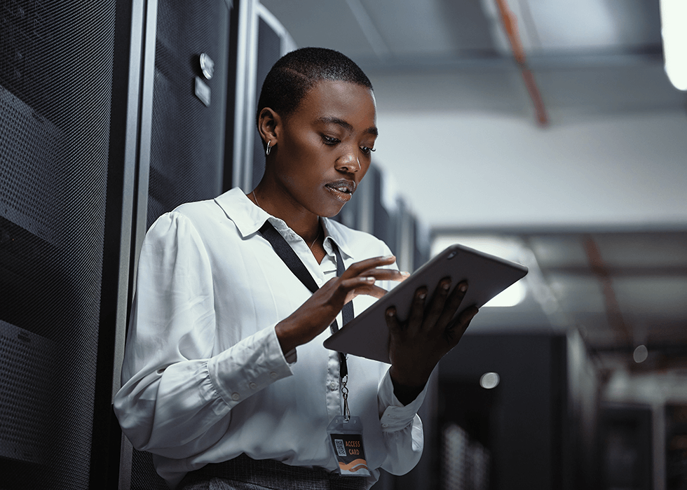 Woman using an ipad in a server room