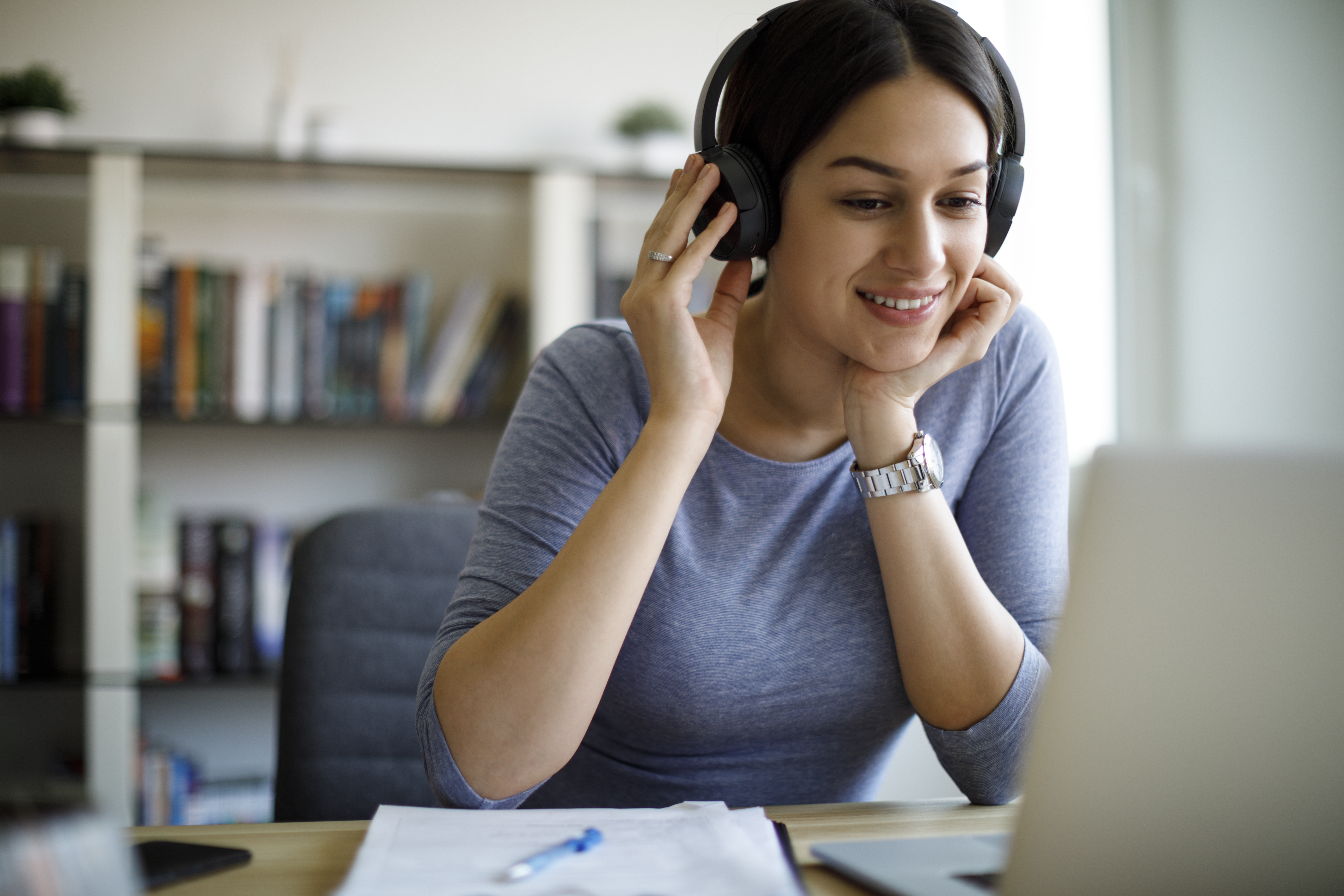 Woman with headphones working from home