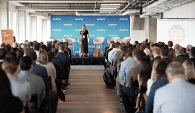 Event Speaker In Front Of Crowd