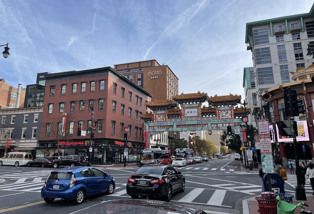 Chinatown's busy 7th and H street NW intersection, featuring the Friendship Archway and the Gallery Place Metro station. 