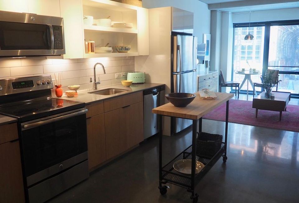 The kitchen and living room in The Channel's one-bedroom model unit