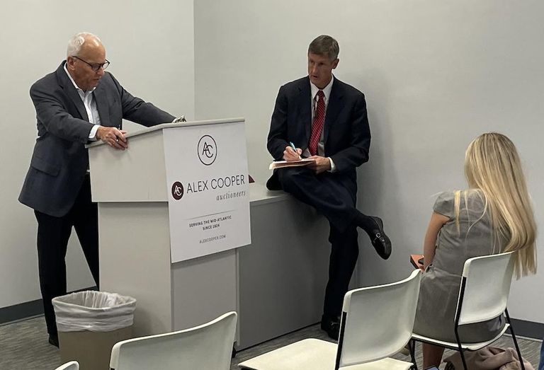 Alex Cooper Vice President Paul Cooper at the auction of 1200 K St. NW on Thursday. 