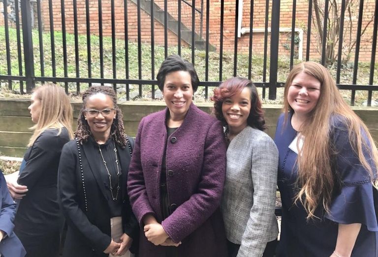 E&G Group CEO's Melissa Steele (right) with Mayor Muriel Bowser (second from left) at the Meadow Green Courts property in 2018. 