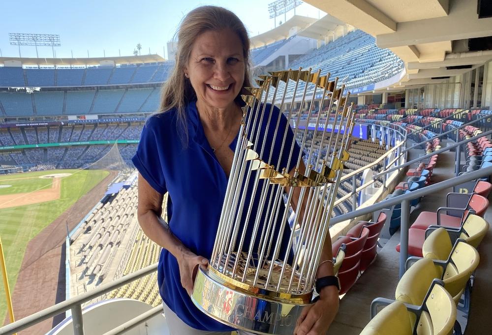 Janet Marie Smith, now the executive vice president of planning and development for the Los Angeles Dodgers, holds the Commissioner Trophy after the team won the World Series in 2020.
