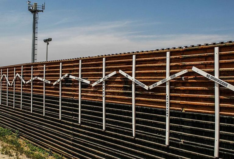 The crosses on the border fence, which Trump wants to replace, represent migrants who died in the crossing attempt, some identified, some not.   