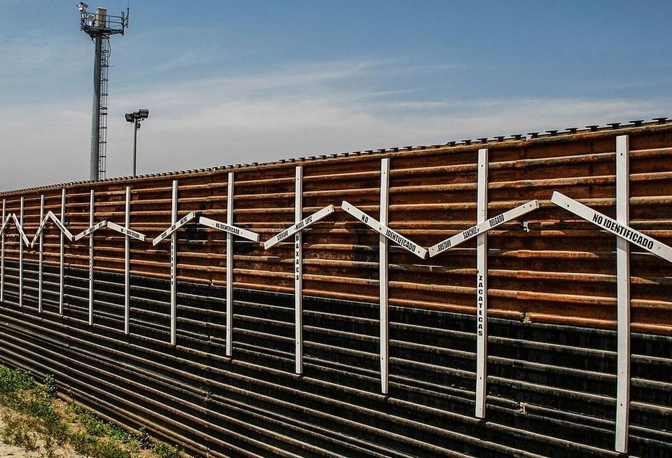 The crosses on the border fence, which Trump wants to replace, represent migrants who died in the crossing attempt, some identified, some not.